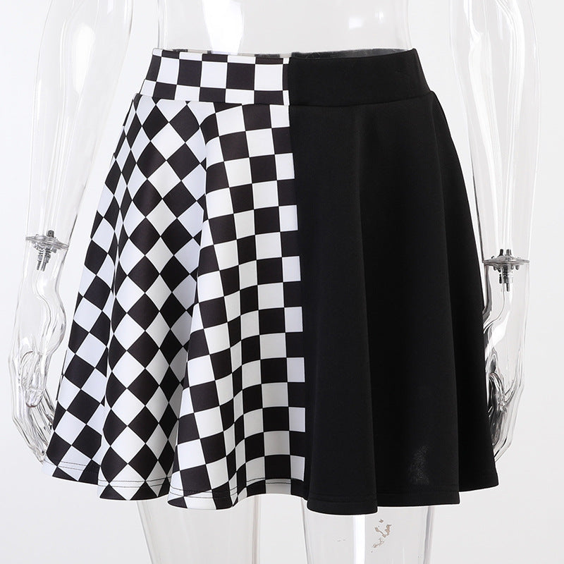 Close-up of checkerboard gothic mini skirt split hem detail, black and white goth femboy skirt