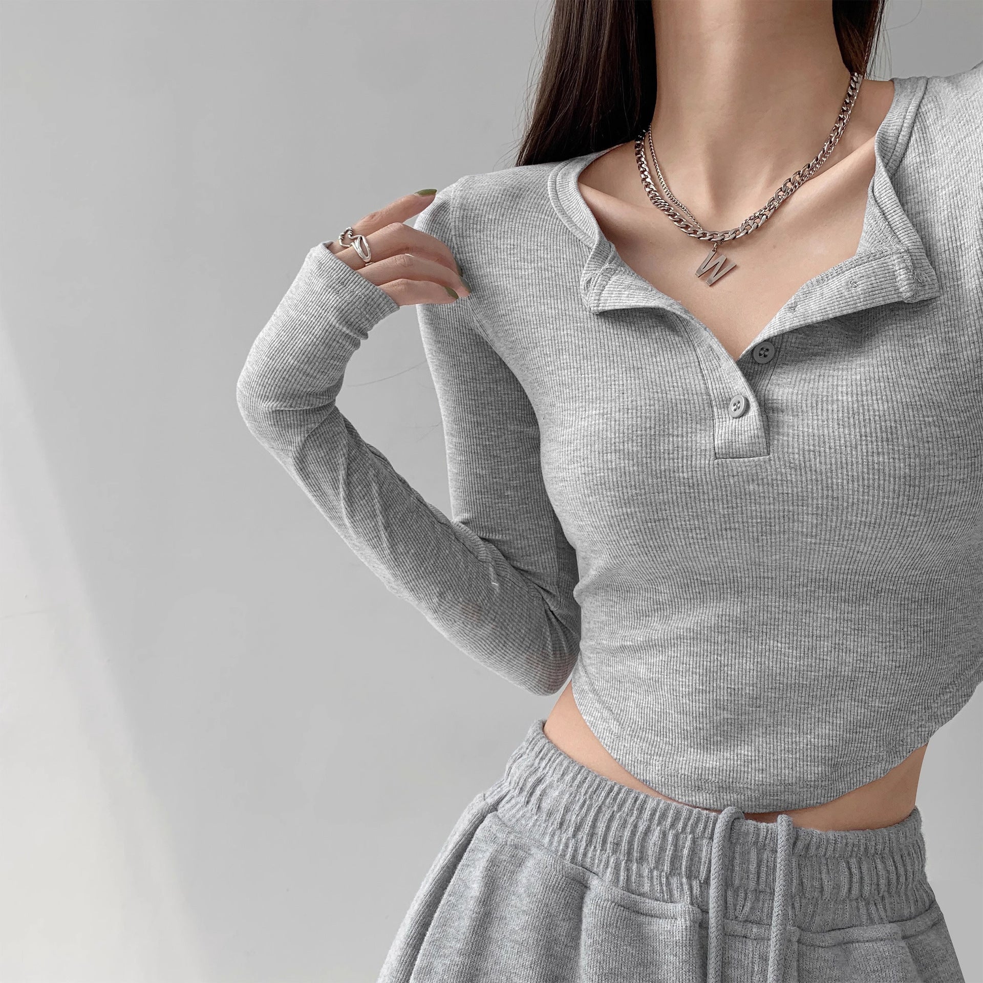 Close-up front shot of grey Collar Femboy Long-Sleeve Tee henley buttons, femboy apparel.