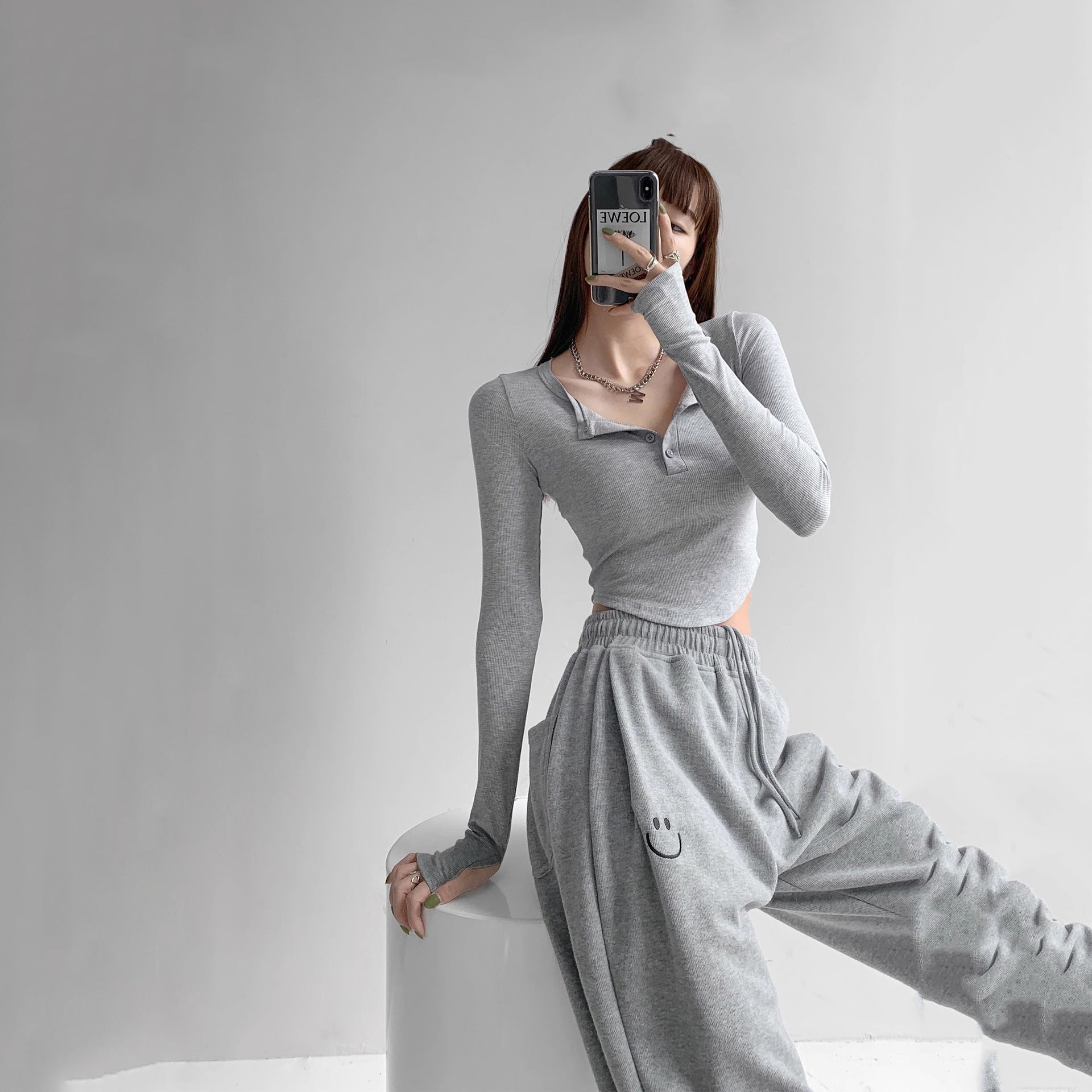 Lifestyle mirror-selfie of model in grey Collar Femboy Long-Sleeve Tee, basic femboy outfit.
