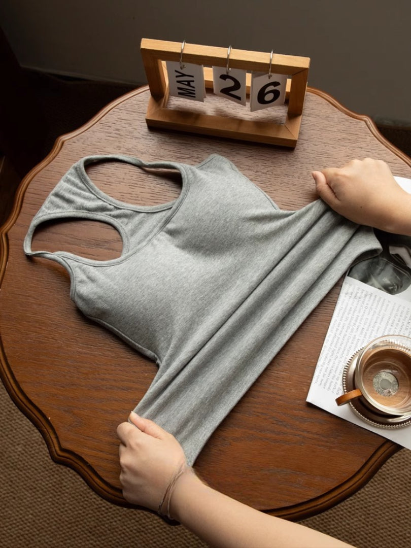 flat-lay shot, stretched view — grey racerback tank pulled to show elasticity, femboy crop top