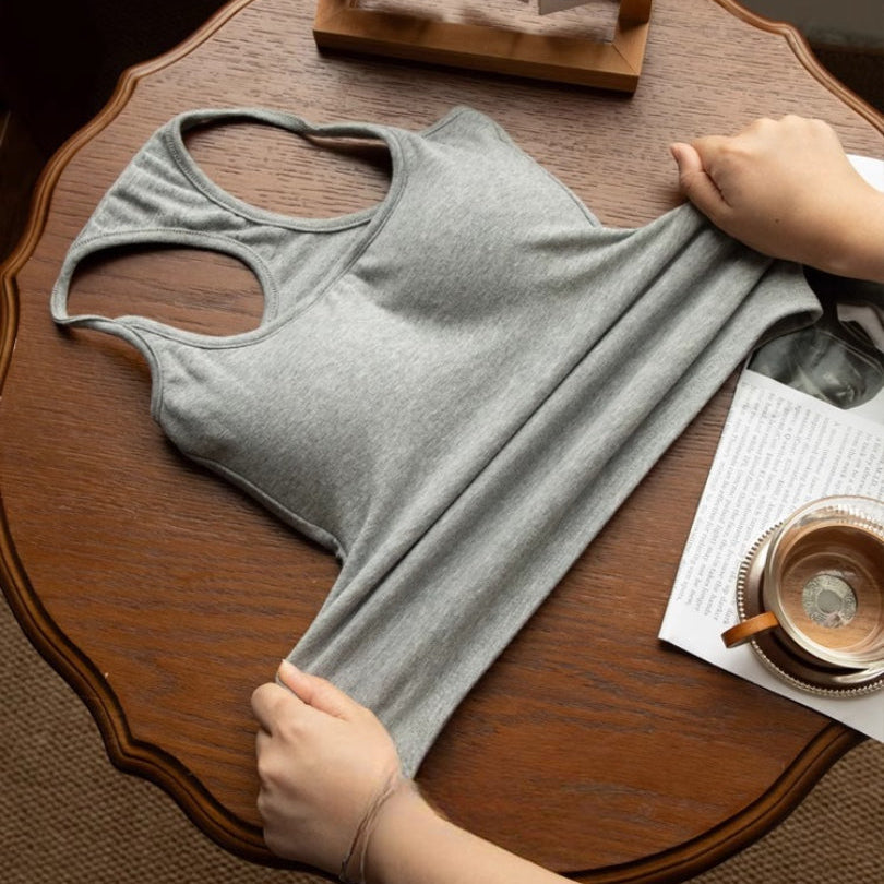 flat-lay shot, stretched view — grey racerback tank pulled to show elasticity, femboy crop top