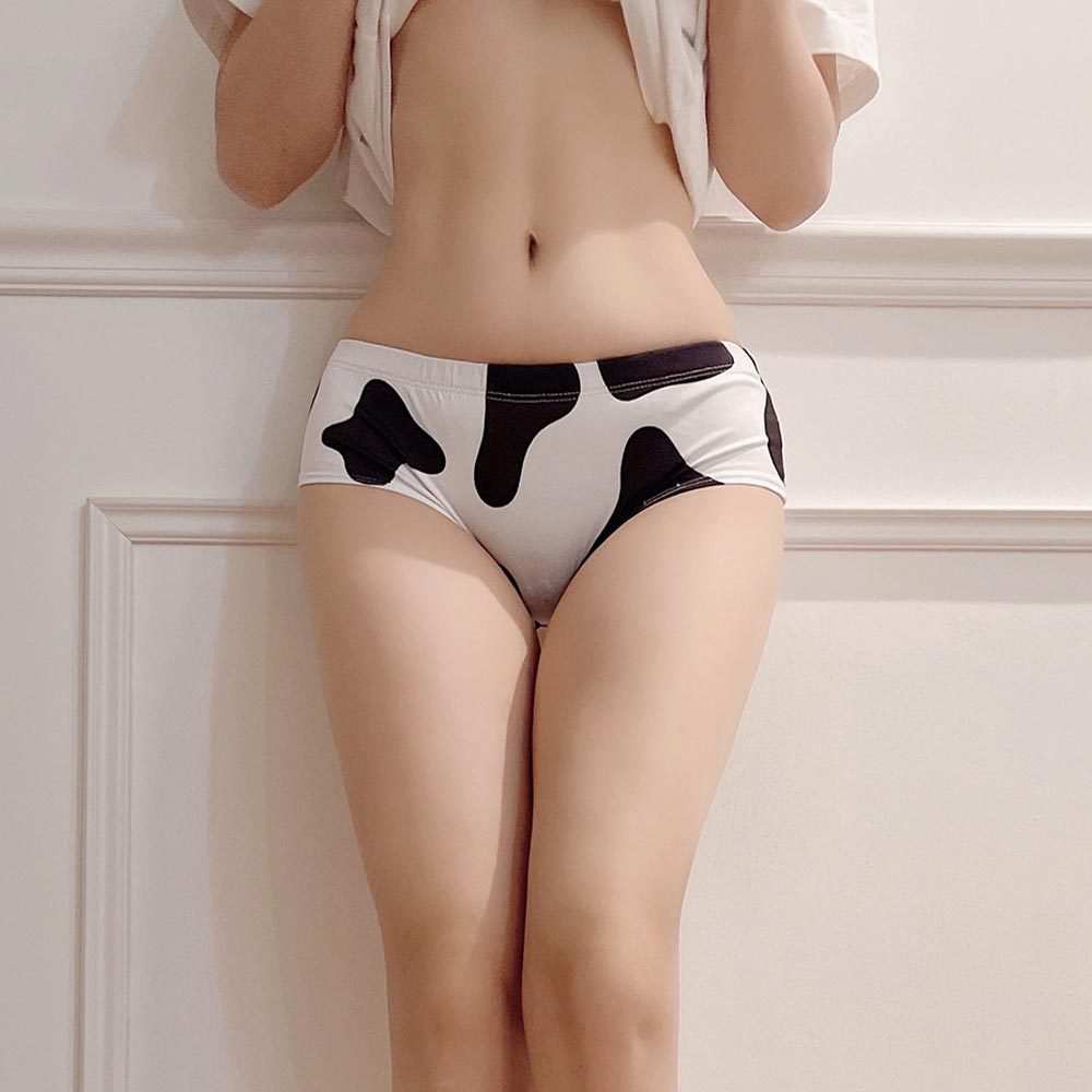 Black and white cow print femboy panties worn lifestyle shot, cute novelty underwear from FemboyBox