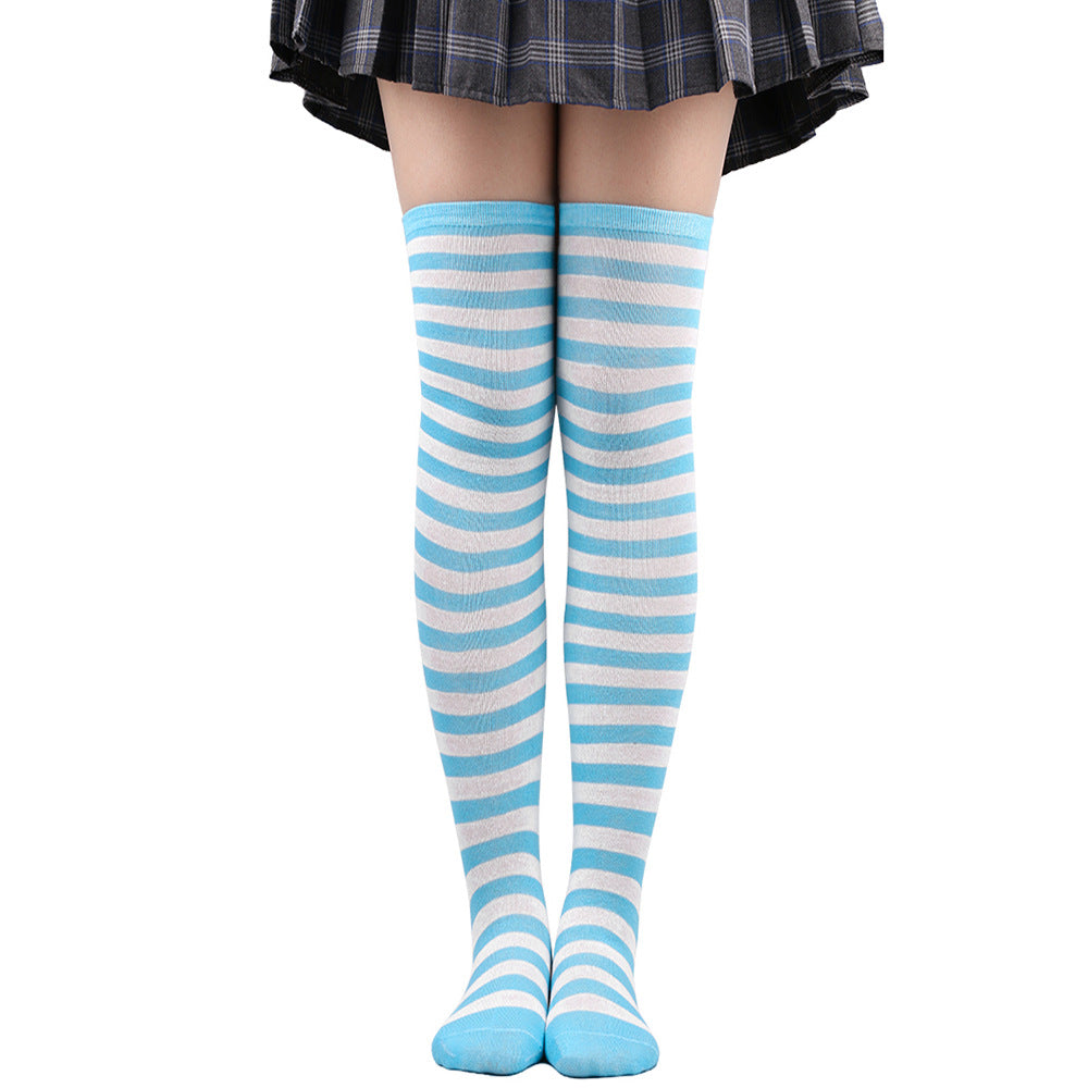 Light blue and white striped femboy thigh high socks worn on legs, front-facing full-length shot showing soft pastel stripes and over-the-knee fit, minimalist white background, femboy clothing and femboy fashion accessory.