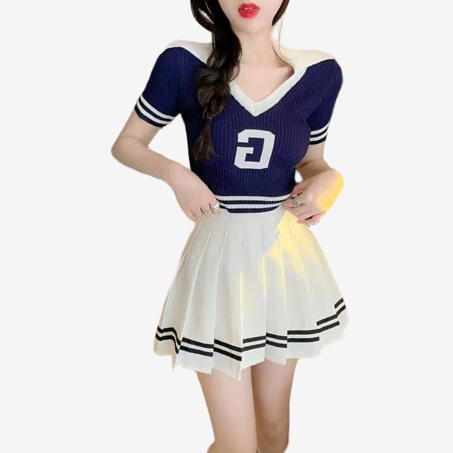 Femboy outfit with cream pleated striped skirt worn on model