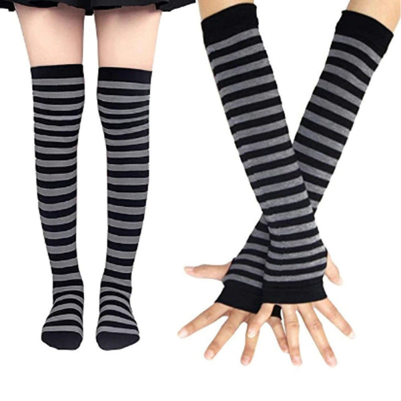 Black and grey striped thigh high socks with matching arm warmers displayed on model legs and hands, cozy cotton femboy clothing ideal for casual femboy outfits
