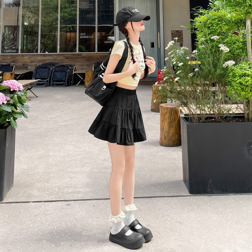 Black high waist tiered ruffle femboy mini skirt, A-line silhouette worn street style from FemboyBox