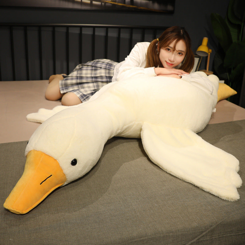 Goose plush body pillow laid across a bed, highlighting its long body, plush wings, and soft white fabric designed for sleeping, cuddling, or lounging.