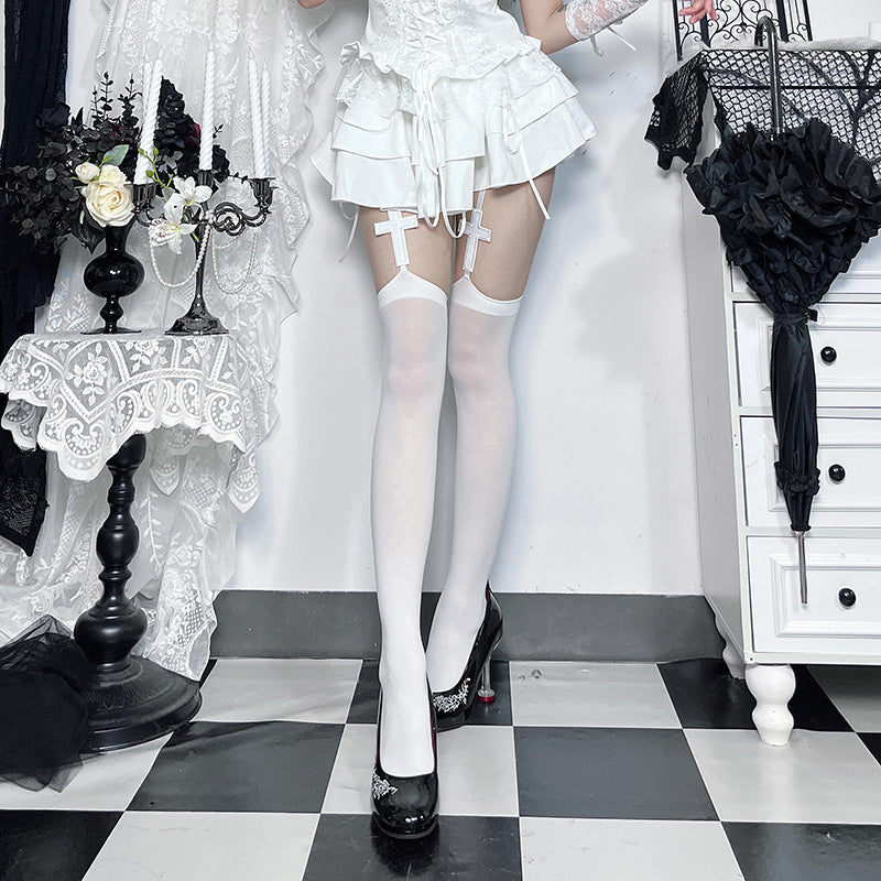 White gothic cross thigh high stockings with suspender garter, goth femboy hosiery lifestyle shot