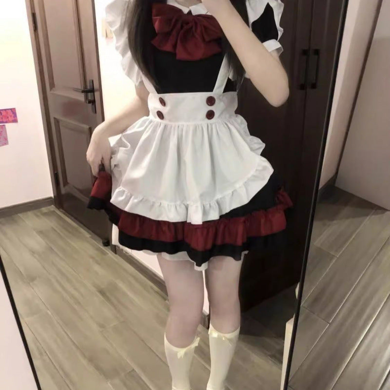 Gothic lolita maid outfit lifestyle shot, red and black femboy dress with white apron overlay