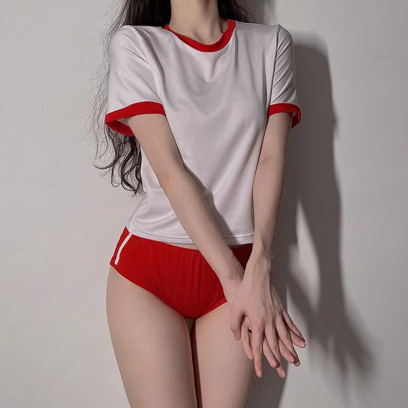 Mirror-selfie torso shot of white Japanese Femboy Gym Kit tee with red collar and sleeves and red shorts, cute femboy clothes shop.