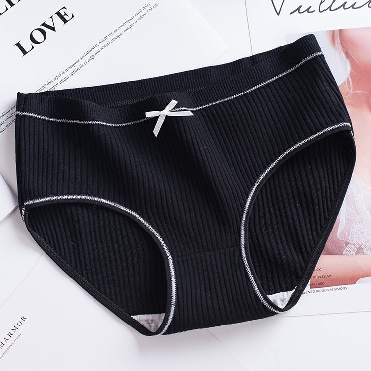 flat-front shot of a single black ribbed brief with contrasting white stitching and lace edging on a clean white surface, perfect for femboy lingerie styling.