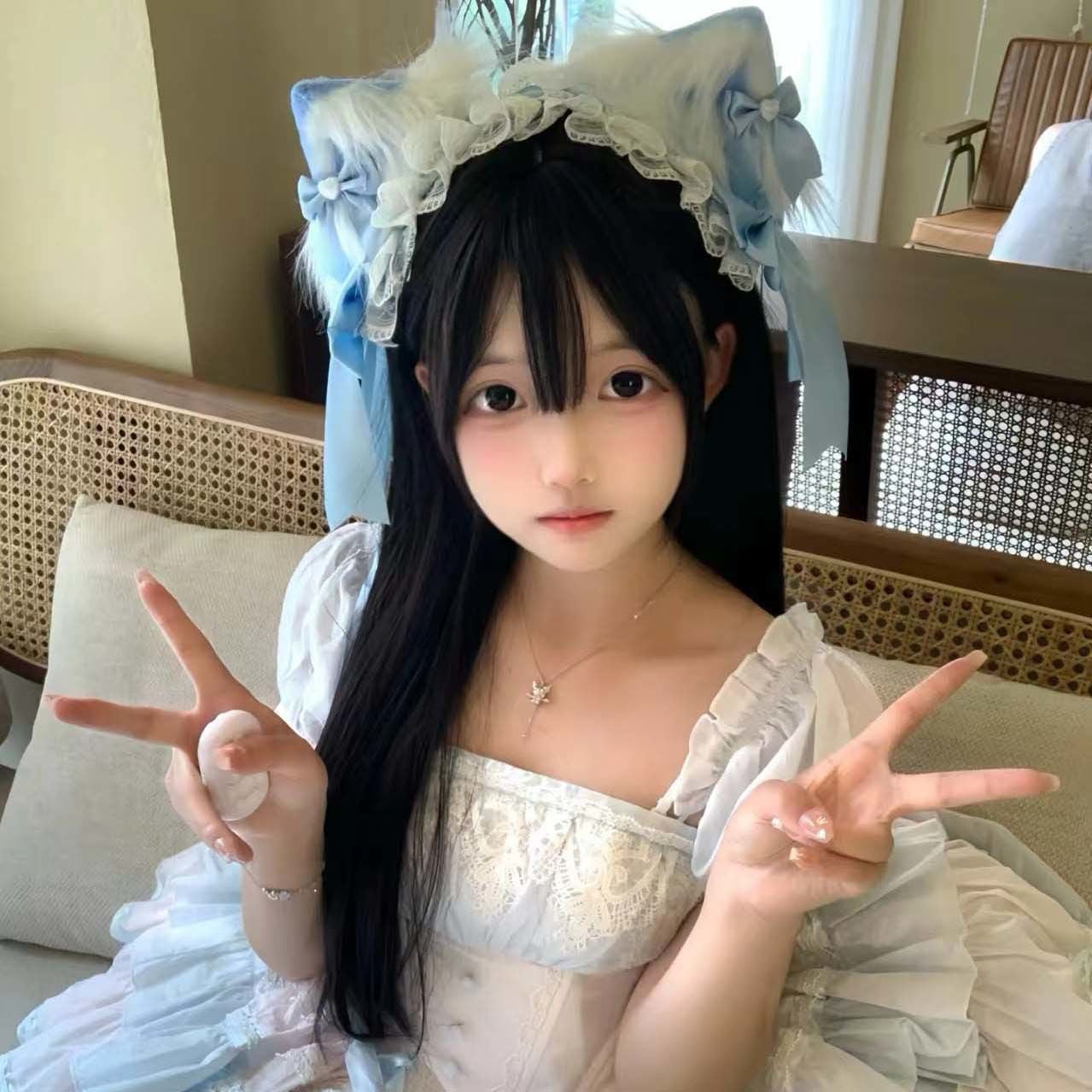 Lolita cat ear clips worn with black hair, cute kawaii femboy accessory lifestyle shot