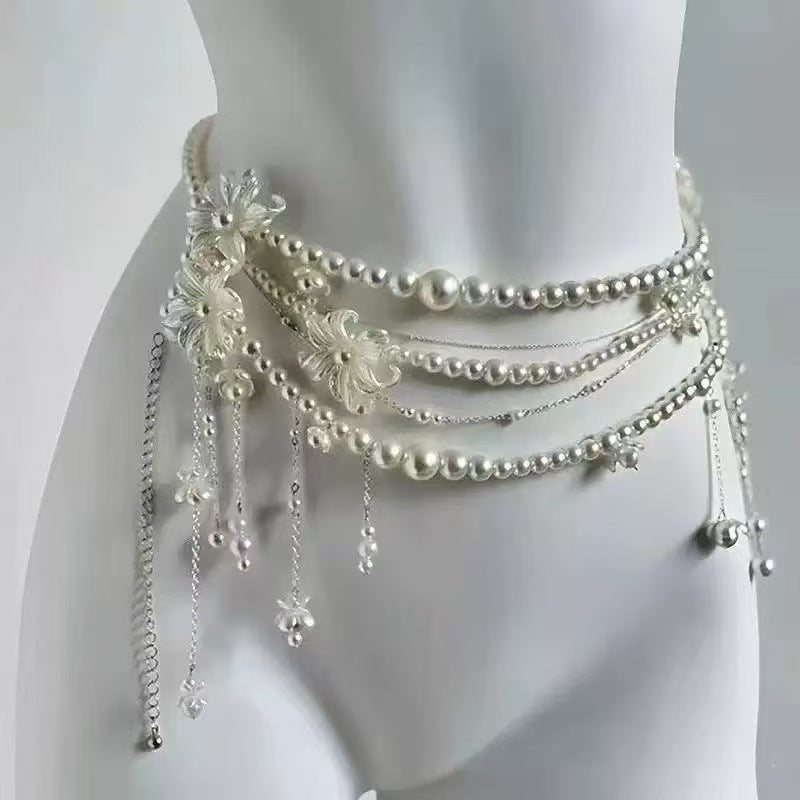 Close-up of layered pearl drape waist chain with crystal drop detail, femboy body jewellery