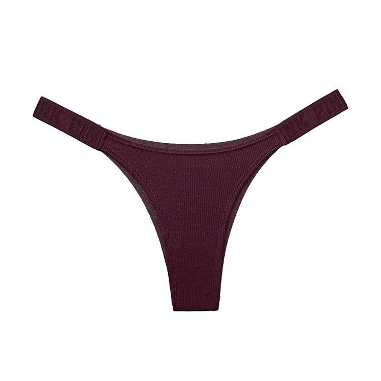 Studio flat-lay of burgundy seamless femboy briefs with ribbed stretch material and side branding, photographed on a white background for a clean ecommerce look, femboy clothing, femboy clothes.