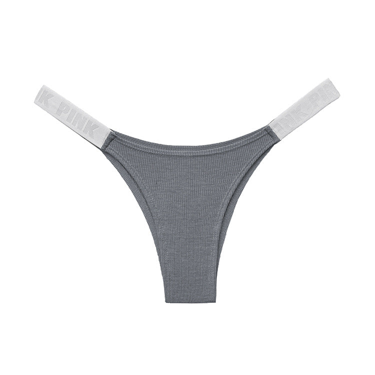 Flat-lay ecommerce photo of grey seamless femboy briefs with white branded straps displayed on a clean white background, showing ribbed texture and minimal design