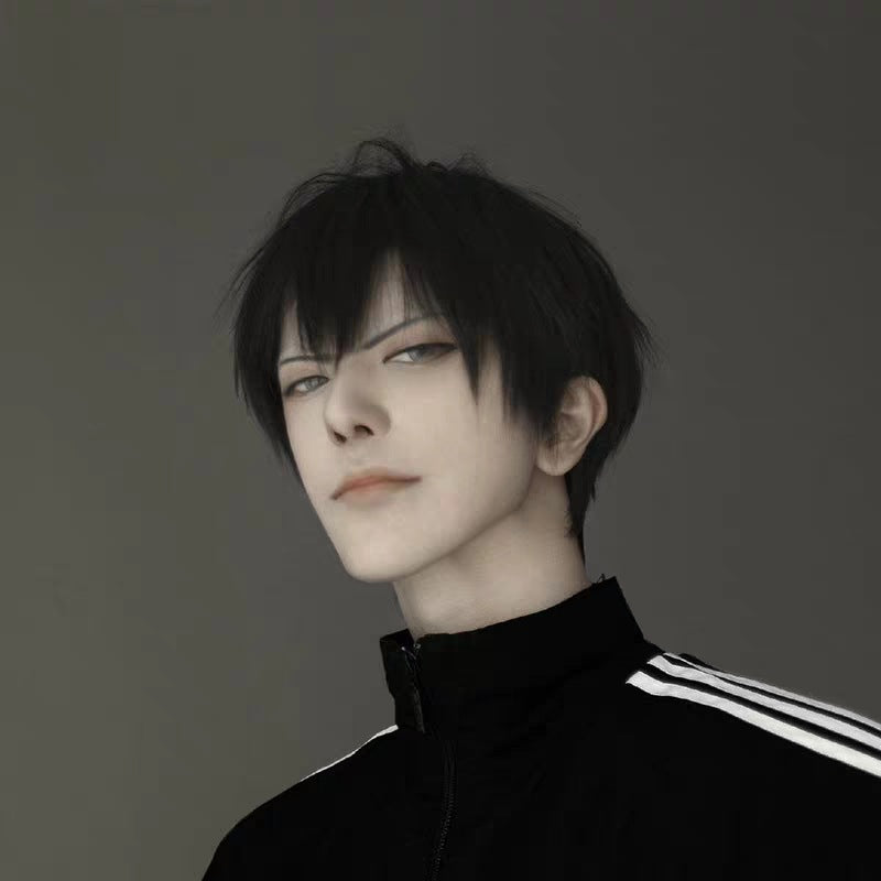 Short bangs femboy wig in jet black with layered straight cut, shown on model from front angle, soft matte texture with natural volume, styled for femboy fashion and androgynous outfits against neutral background.