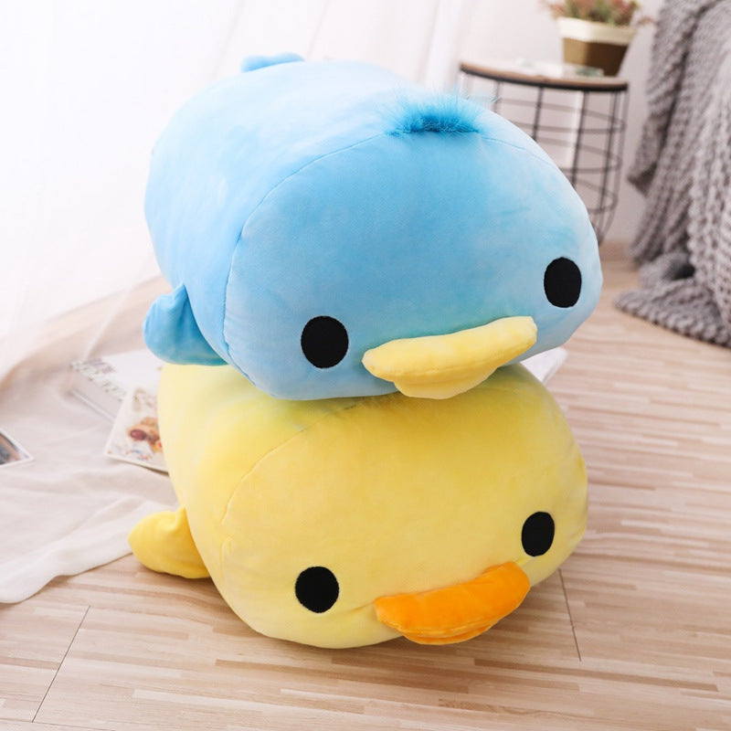 Soft Duck Plush with a blue duck plush stacked on top of a yellow duck plush, photographed in a cozy indoor setting on a wooden floor, featuring a minimalist lifestyle aesthetic with soft natural lighting.