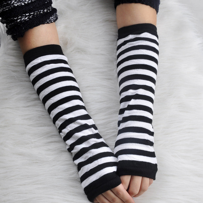 White and black striped fingerless arm warmers lifestyle shot, goth femboy aesthetic elbow sleeve