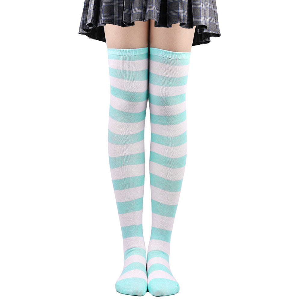 Mint green and white striped femboy thigh high socks shown worn from a slightly adjusted front angle, soft pastel striped femboy fashion item on white background.