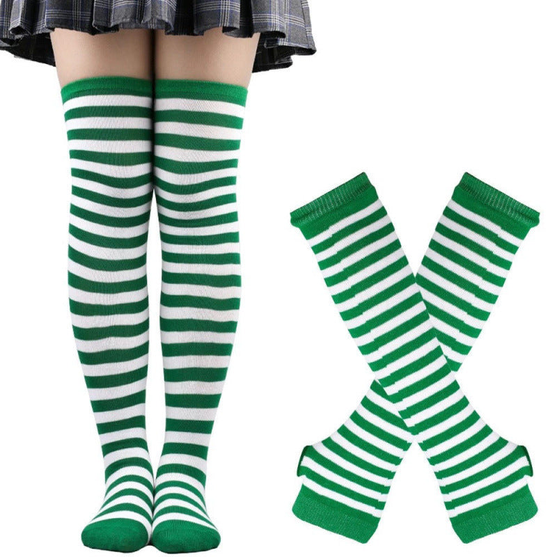 Green and white striped thigh high socks worn on model, front-facing full leg view with matching striped handwarmers displayed beside, soft cotton fabric, white studio background, femboy outfits style.