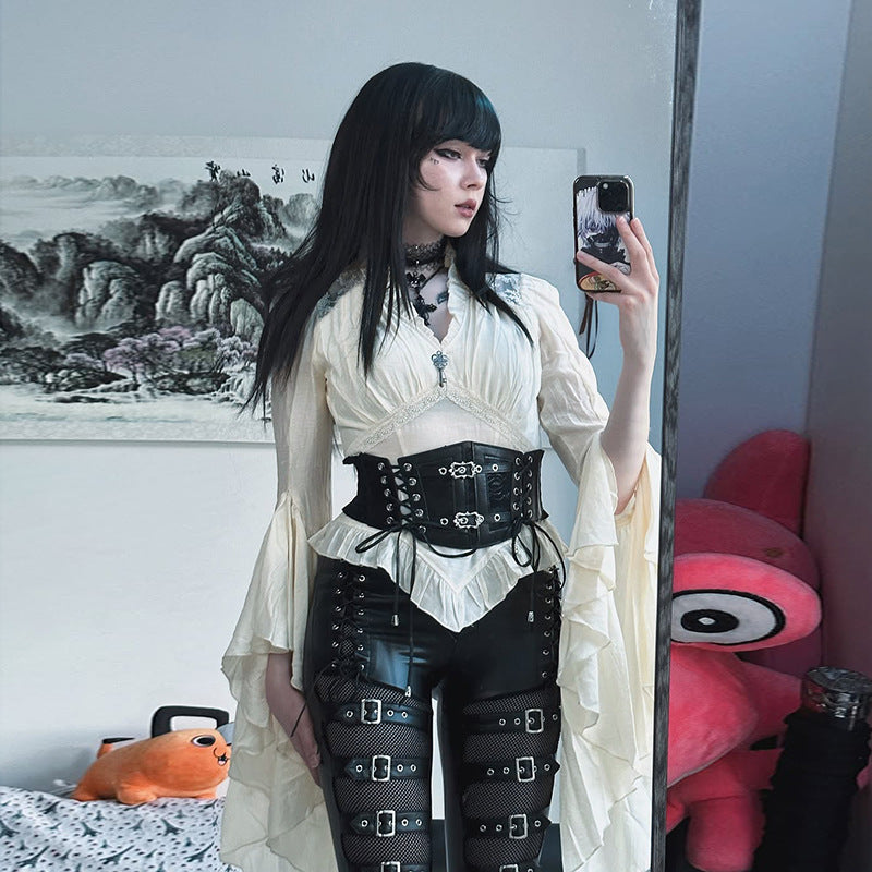 White Victorian ruffle blouse styled with black corset belt, goth femboy outfit lifestyle shot