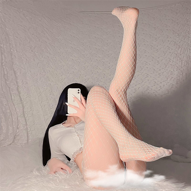 White fishnet stockings worn in a mirror selfie pose, cozy neutral background, soft lighting, playful femboy aesthetic