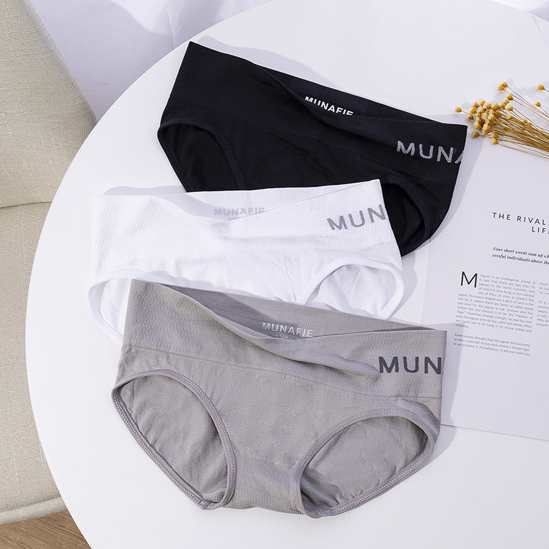 Overhead shot of three pairs of Solid Sport Panties (black, white, gray) on a white table, showcasing sleek design, femboy clothing, and comfort. The background features a neutral setting, emphasizing the simplicity and versatility of femboy outfits and femboy clothes.