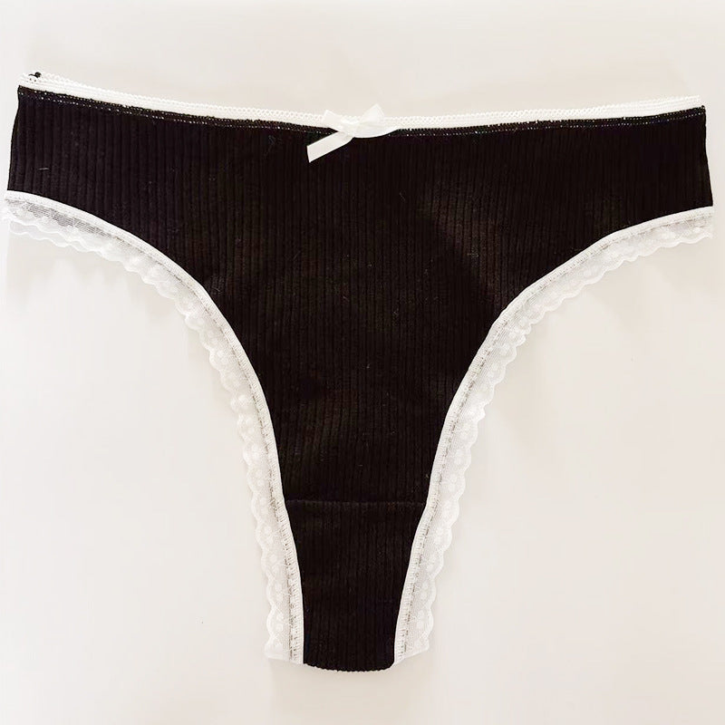 Flat-lay of a black Bowknot Lace Trim Thong with a ribbed design, contrasting white lace trim, and a central bowknot. Captured on a neutral background to highlight bold femboy style.