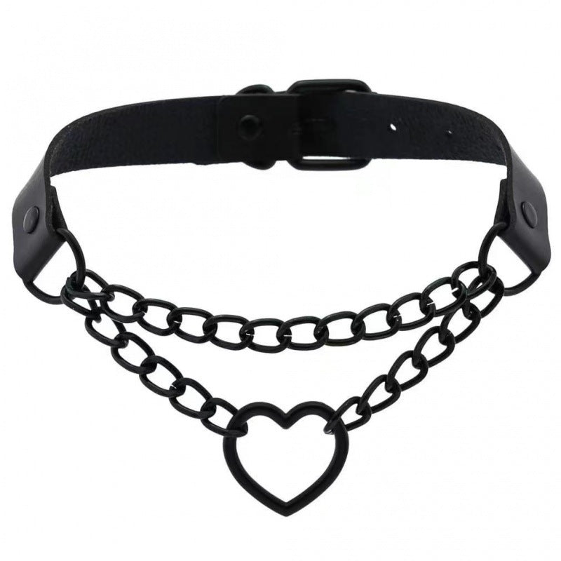 Black gothic femboy choker featuring black chain and heart-shaped ring pendant, adjustable leather strap, dark aesthetic femboy fashion accessory on white background