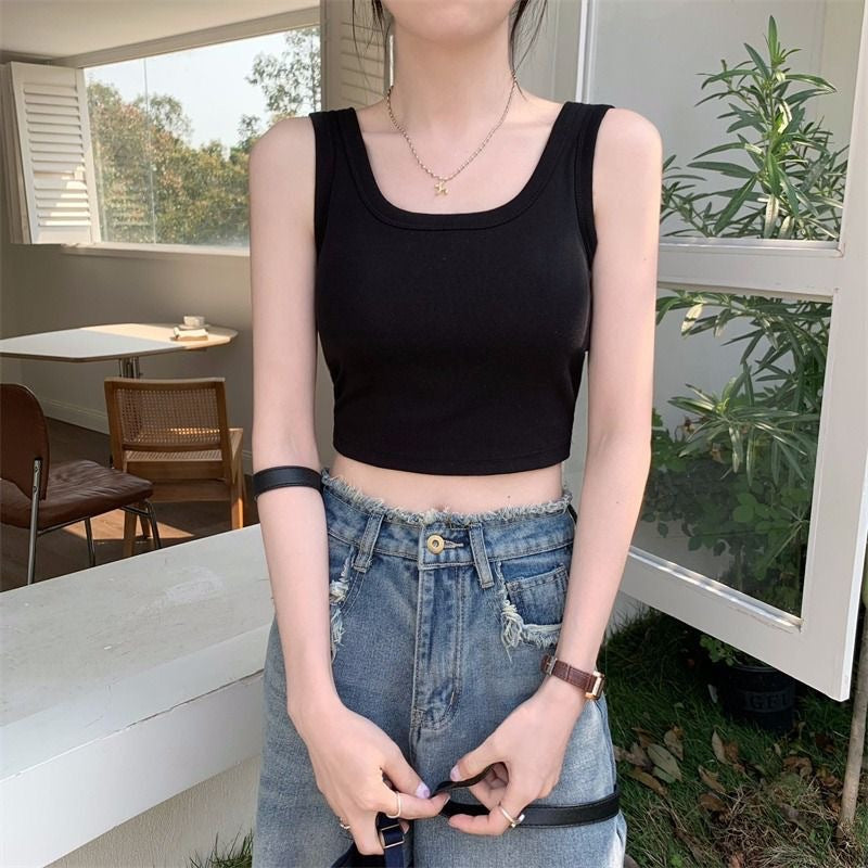 Front-facing view of the Padded Short Camisole in black, paired with high-waisted ripped jeans in a casual outdoor setting. Ideal for trendy femboy outfits and everyday femboy clothing.