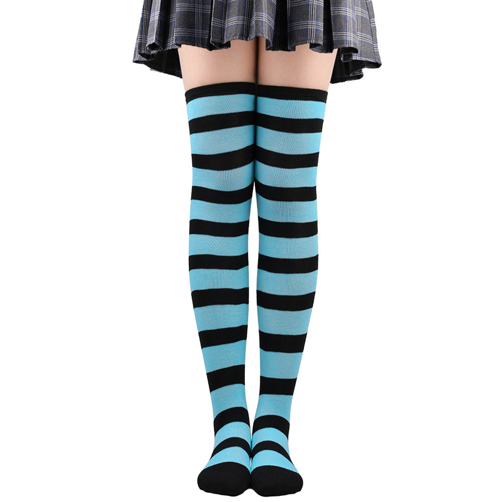 Blue and black striped femboy thigh high socks displayed in a clean front-facing pose, over-the-knee length with vivid alternating stripes, modern femboy clothing aesthetic.