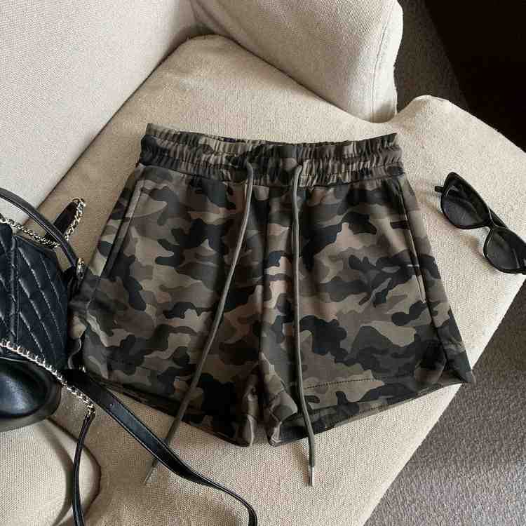 Army green camo print shorts with elastic drawstring waist and side pockets, front view