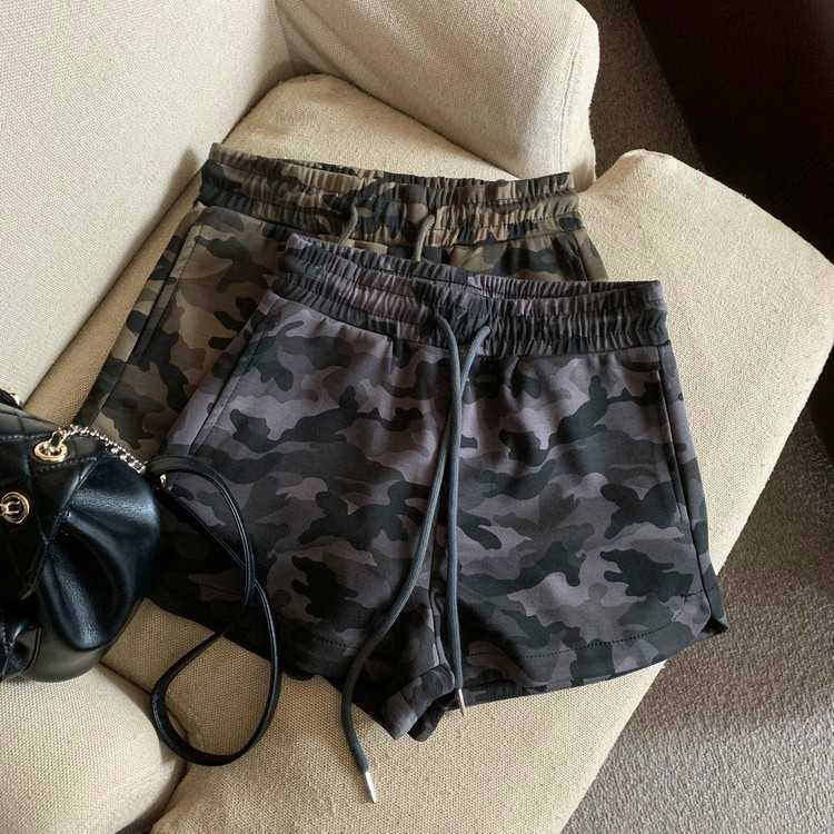 Camo print shorts in army green and grey camo with elastic drawstring waist, flatlay on sofa | FemboyBox