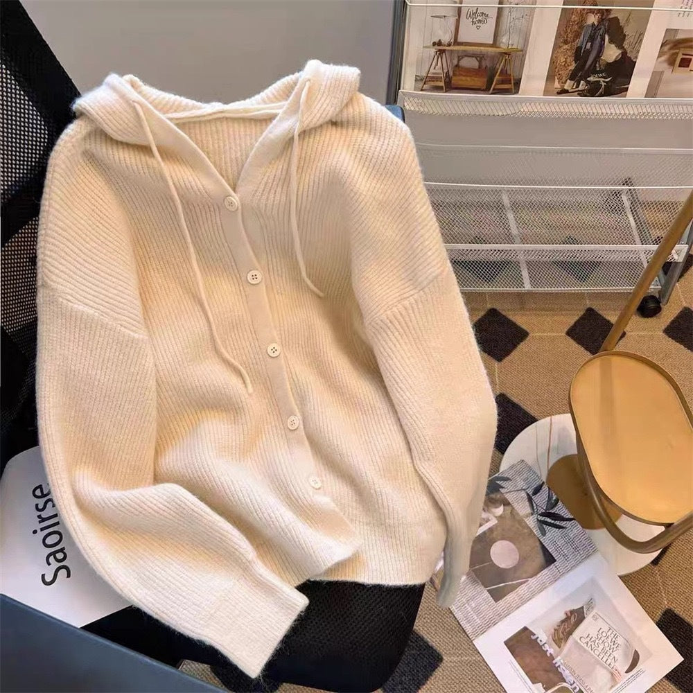 Cream-coloured soft knit femboy hoodie featuring button closures, laid on a stylish background, ideal for femboy clothes and warm casual femboy fashion.