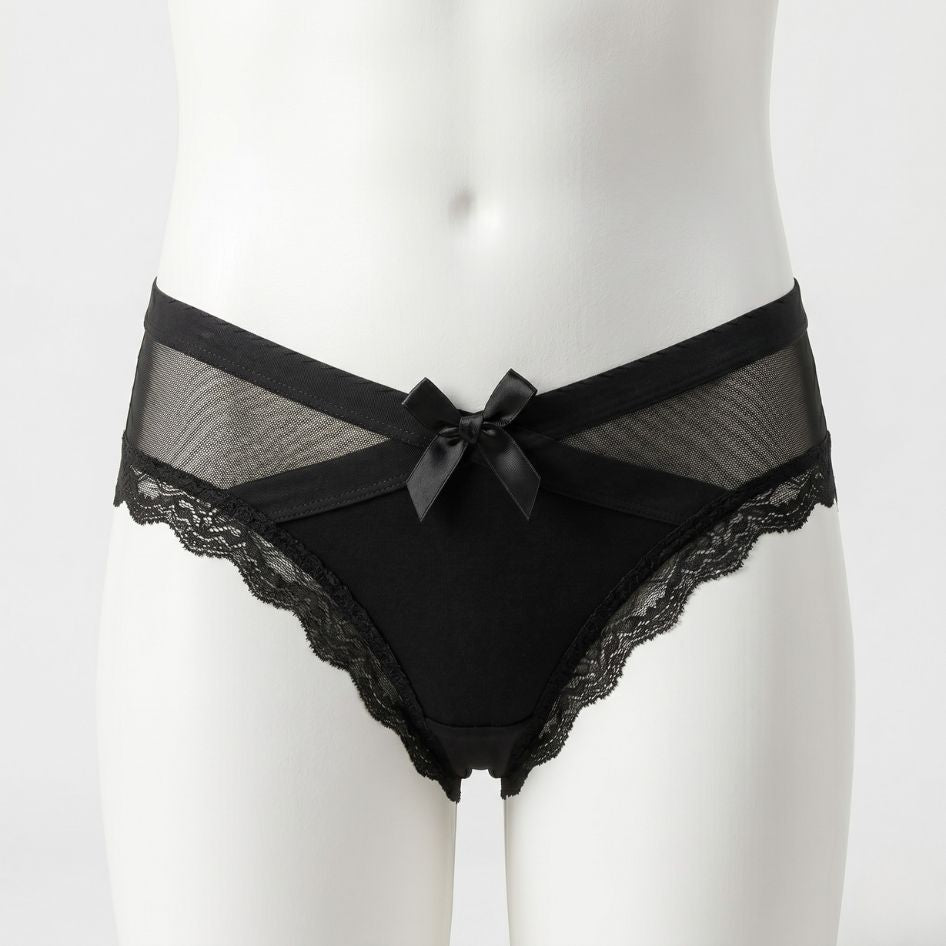 Black femboy lace panties with sheer mesh V-panel and satin bow detail, scalloped lace trim on mannequin