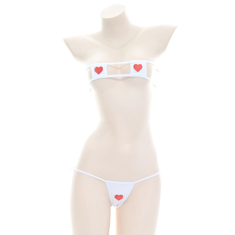 Mannequin displayed in a white Heart Embroidery Bikini Set, embodying femboy style with red heart details on the bandeau top and bikini bottoms, against a plain background.