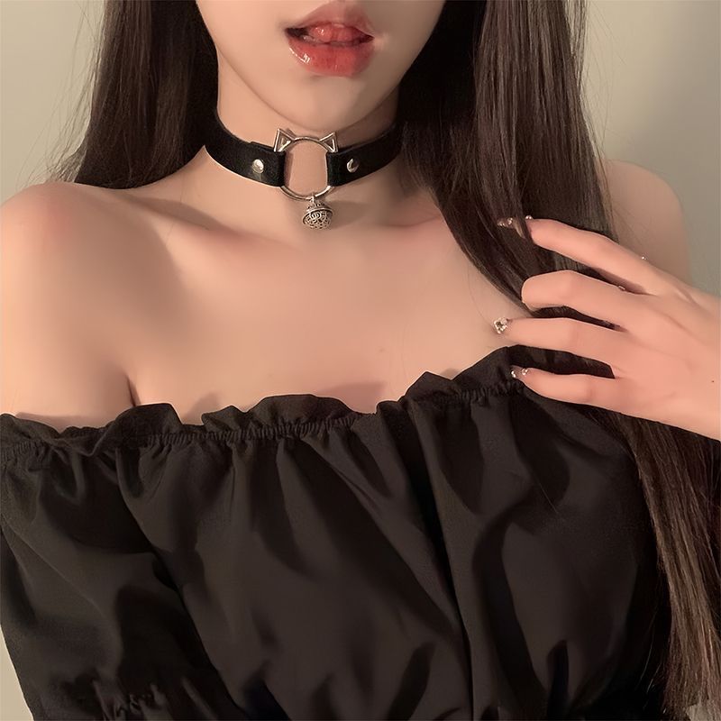 Stylish black cat choker with bell, part of a femboy fashion accessory collection, paired with a black top.