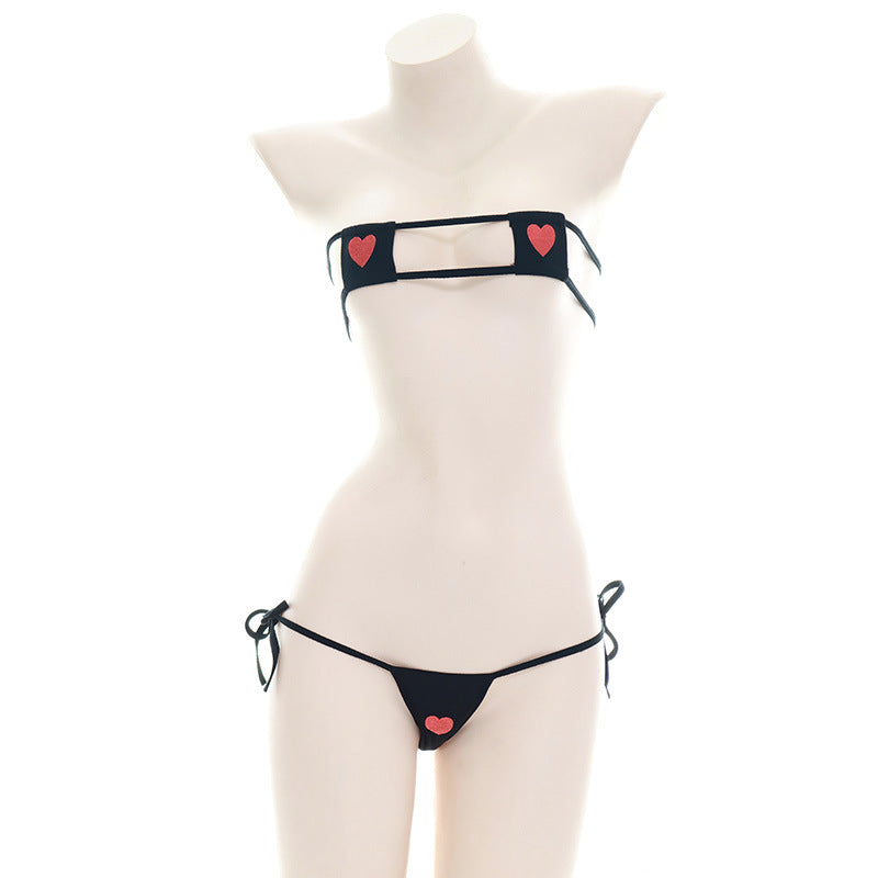 Front view of a mannequin wearing a black Heart Embroidery Bikini Set, highlighting femboy fashion with heart accents and tie-side bikini bottoms on a neutral backdrop.