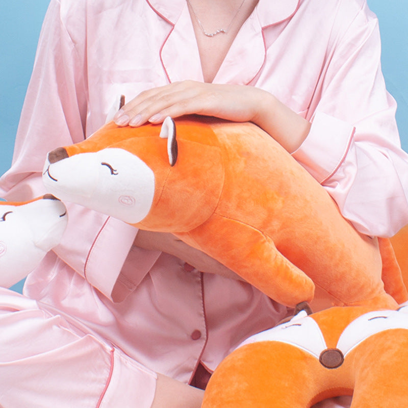 Close-up lifestyle shot of the Femboy Fox Plushie cradled in a seated pose, captured from a slightly elevated front angle against a pastel blue background, highlighting plush texture and rounded shape, a cute accessory often paired with cozy femboy outfit aesthetics.