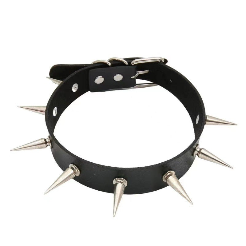 Black spiked gothic femboy choker made from faux leather, front-facing studio product shot showing silver cone spikes and adjustable buckle strap, bold punk-inspired femboy accessory on clean white background.