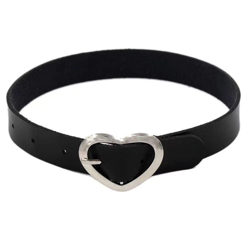 Black leather femboy choker with silver heart buckle, close-up front view on white background, minimalist gothic femboy fashion accessory