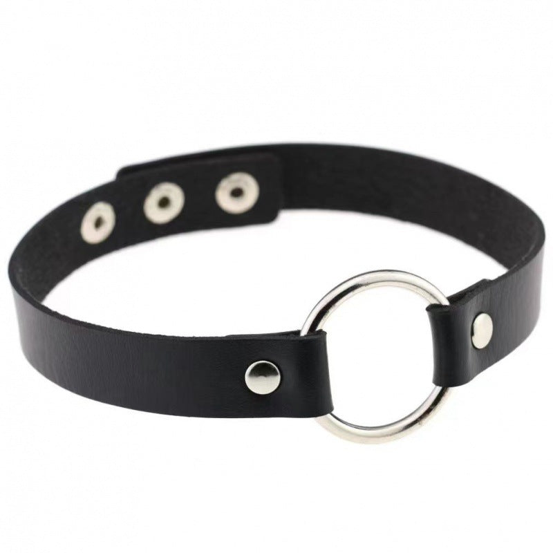 Black leather gothic choker featuring a silver O-ring center detail with adjustable snap closure, clean minimalist femboy fashion choker displayed on white background, studio product image.