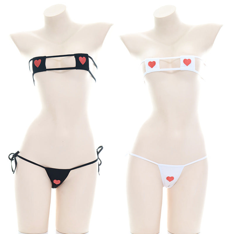 Two mannequins side by side, showcasing the Heart Embroidery Bikini Set in black and white versions, perfect for femboy outfits, each adorned with contrasting heart accents, set against a simple backdrop.