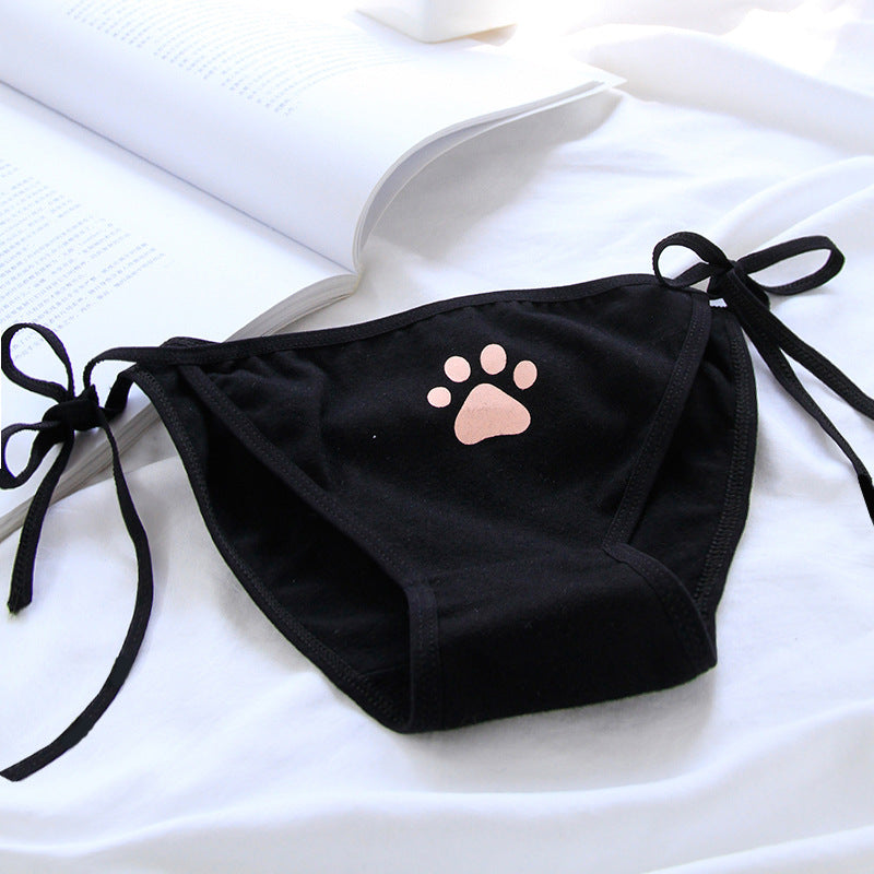 Close-up of black Paw Panties with a soft pink paw print design, displayed on a white background. A fun and stylish addition to femboy outfits, perfect for embracing femboy fashion.