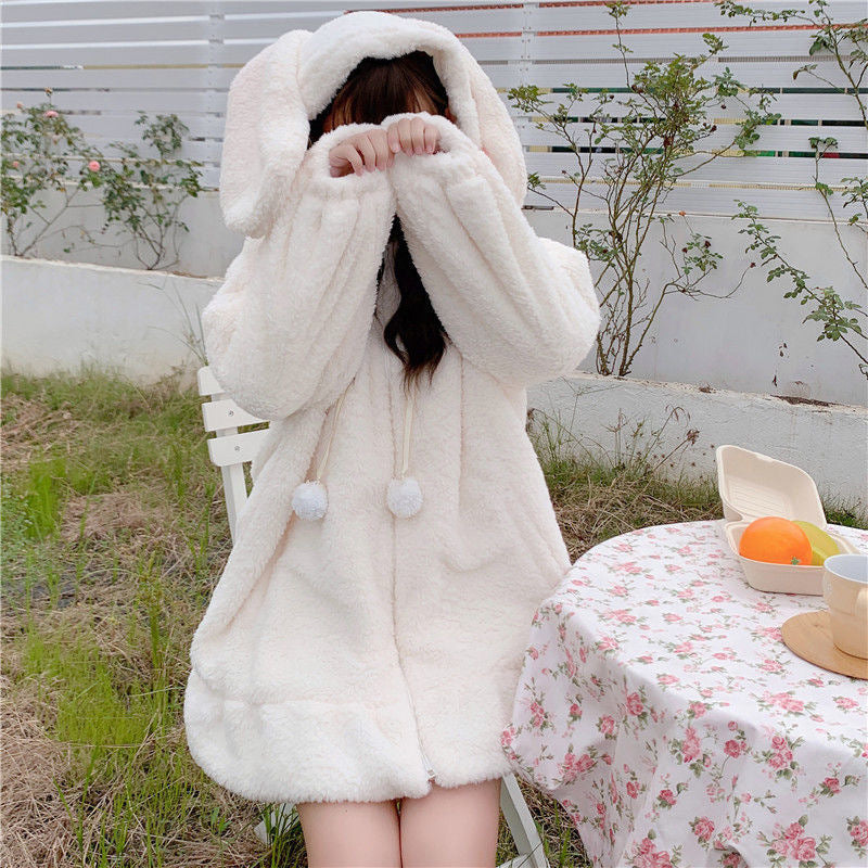 White plush rabbit ear hooded coat for femboy outfits, oversized fluffy kawaii outerwear lifestyle shot from FemboyBox