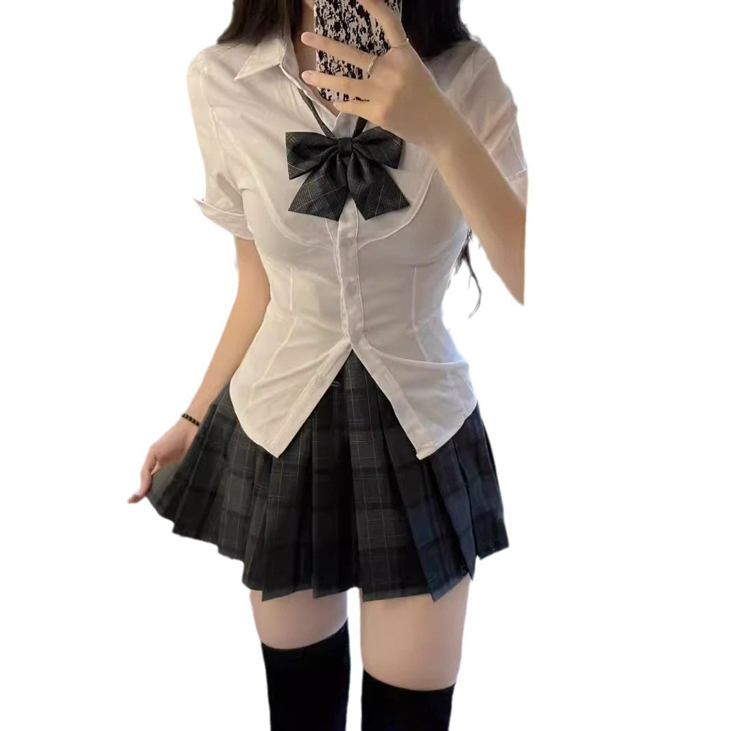 Full look of the Femboy Schoolgirl Kit with a fitted white short sleeve shirt and plaid skirt, styled with a plaid bow, perfect for a stylish femboy outfit on a white background.