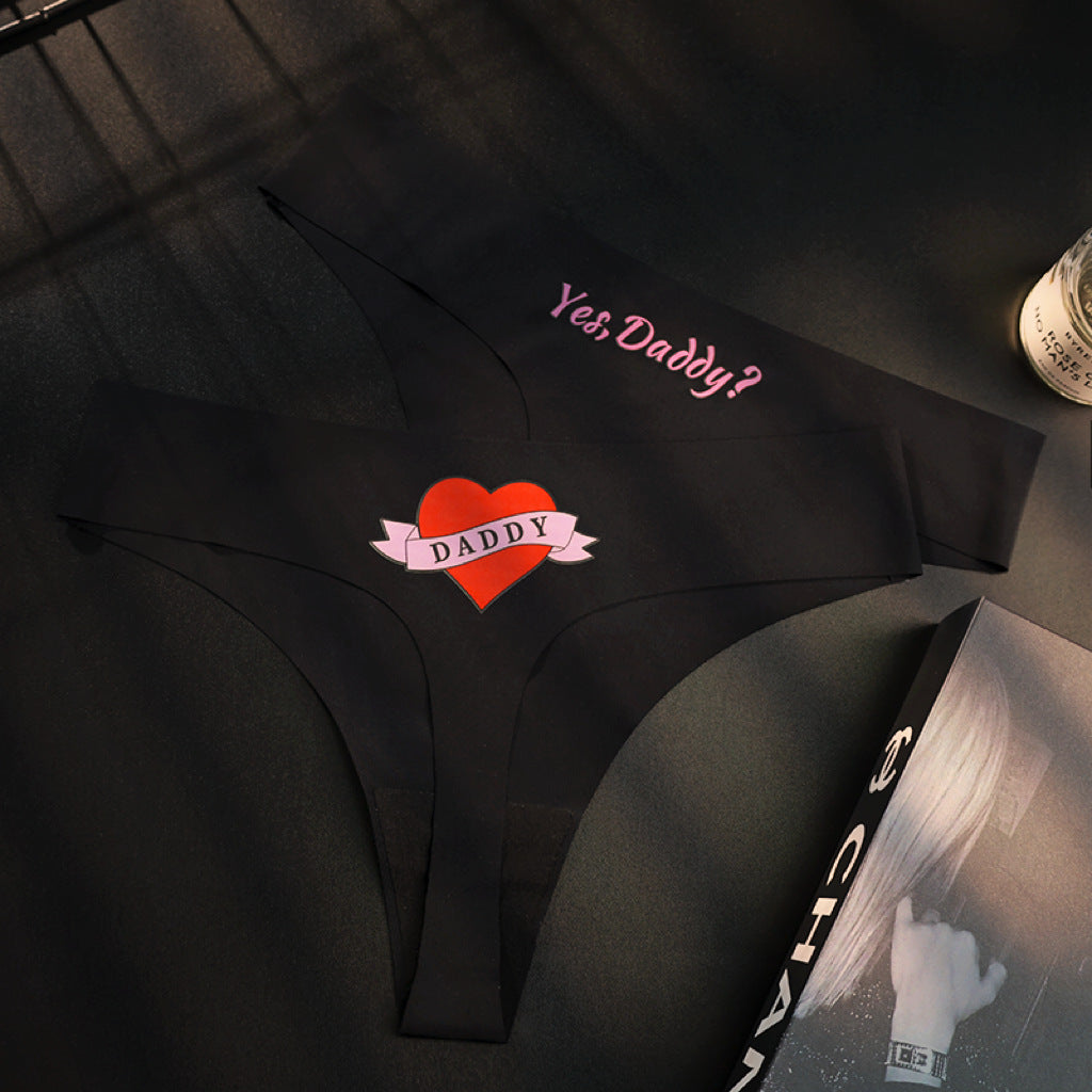 Black Yes Daddy embroidered femboy thong lifestyle shot, cute femboy lingerie detail close-up