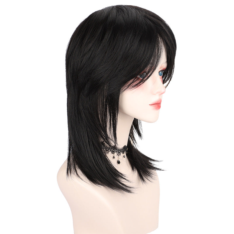 Side-profile studio shot of a black femboy wolf cut wig displayed on a mannequin head, featuring layered shaggy lengths and wispy ends, photographed at a right-facing angle with a clean white background, showcasing soft matte synthetic fibers for modern femboy fashion styling.