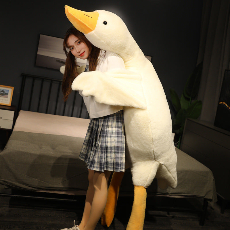 Person hugging a giant goose plush body pillow, showing the pillow’s tall height, soft texture, and wraparound wings for full-body comfort.