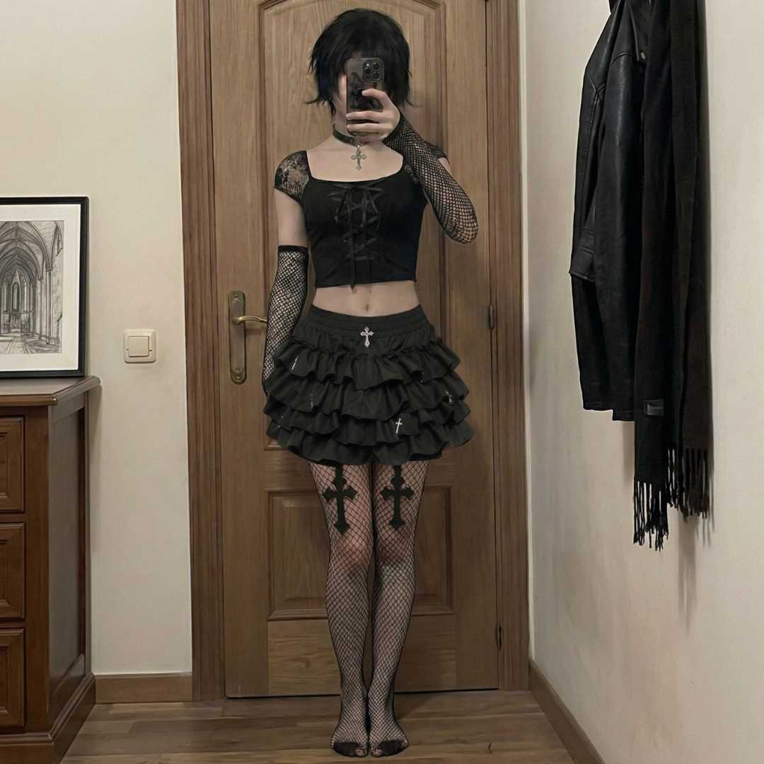 Full goth femboy outfit mirror selfie with lace crop top, layered ruffle skirt, fishnet tights and fingerless gloves
